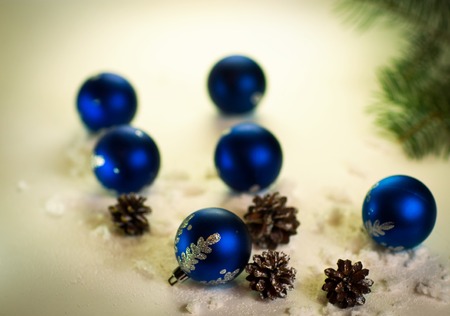 blue Christmas balls on white background with fir conesの写真素材