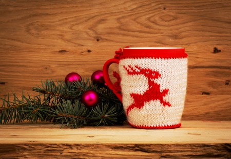 Christmas mug with Christmas decorations on wooden backgroundの写真素材