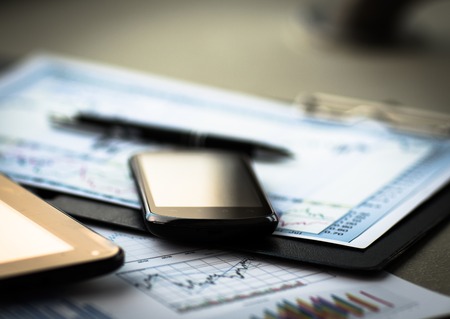 Business chart with smart phone and penの写真素材