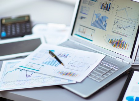 Businessman analyzing investment charts with laptop. Accounting