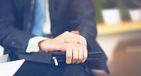 confident businessman with a folder in his hands in the officeの写真素材