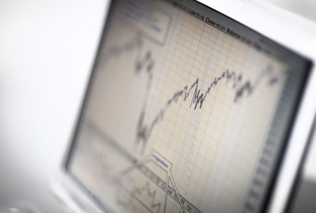 Businessman analyzing investment charts with laptop. Accounting