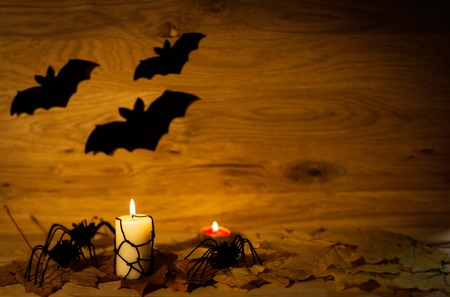 Halloween decoration with spider on web,  and candles on wooden backgroundの写真素材