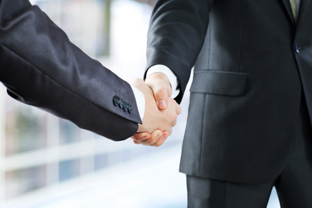 the handshake of two businessmenの写真素材