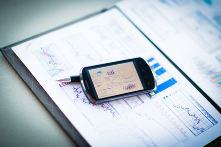 Business chart with smart phone and penの写真素材