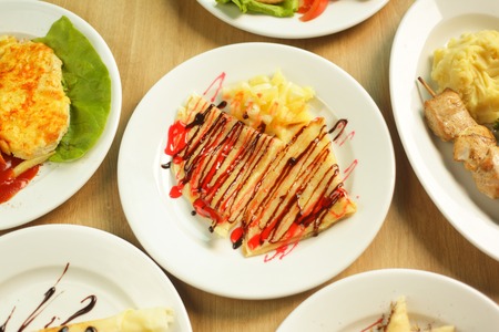 lot of delicious dishes on the table in the children's restaurantの写真素材