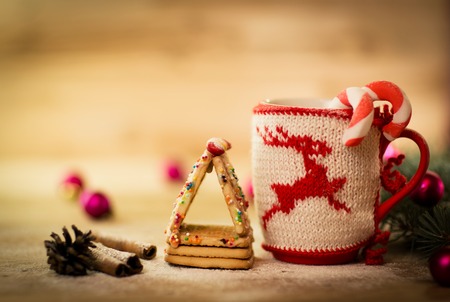Christmas mug with decorations and sweets on wooden backgroundの写真素材