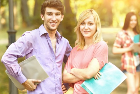 group of happy students with books in the Park on a Sunny day.の写真素材