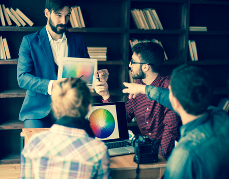 group of designers discuss the color palette in a modern officeの写真素材