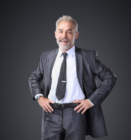 Successful, confident businessman holding his hands at  belt.の写真素材