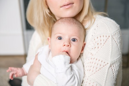 a small child in the arms of mom . positive human emotions, feelingsの写真素材