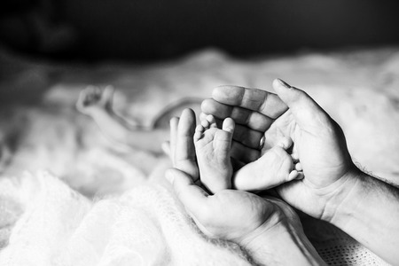 black-and-white photo in retro style.happy mother hugging the leの写真素材