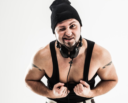 portrait of a badass rapper with headphones on a white backgrounの写真素材