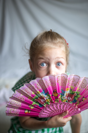 portrait of a little girl with fanの写真素材