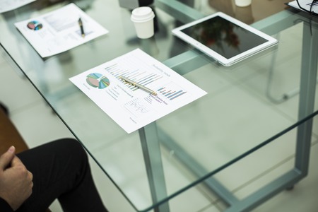 financial chart,glasses and pen on the workplace of the businessmanの写真素材