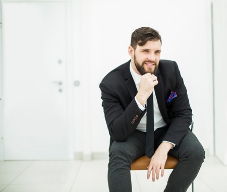 successful businessman in a business suit sitting on office chairの写真素材
