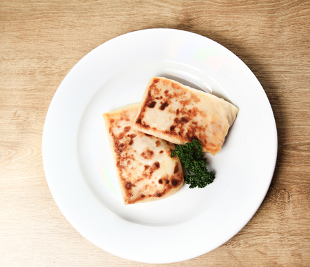 pancakes on white plate on wooden backgroundの写真素材