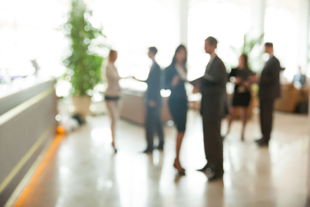 Blurred background : employees work in the lobby, spacious officeの写真素材