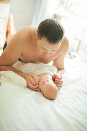 happy father holding hands the newborn babyの写真素材