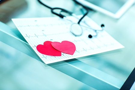 health concept: two red paper heart on the electrocardiogram, the cardiologist.の写真素材