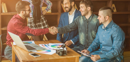 advertising Manager with a handshake greets the customerの写真素材