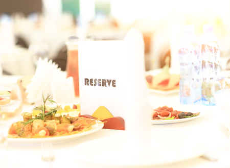 Reserved sign on a restaurant tableの写真素材