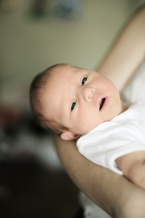 newborn baby in the arms of a young motherの写真素材