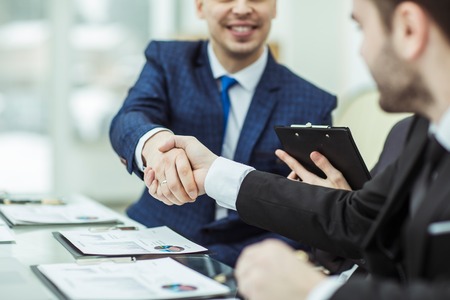 handshake business partners after discussion of the financial agreementの写真素材
