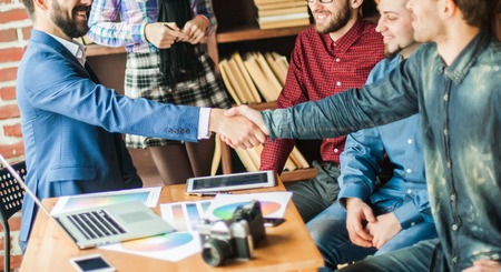 handshake business partners at a meeting in creative officeの写真素材