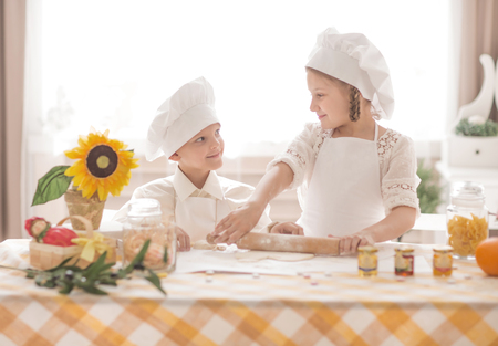 happy little children in the form of chef to prepare deliciousの写真素材