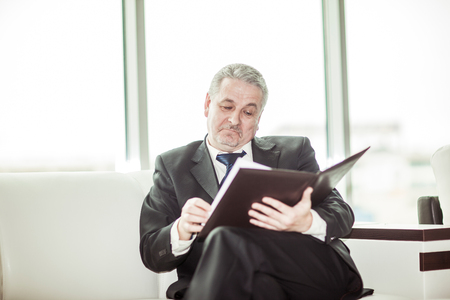 experienced lawyer reviews the documents with the terms of a new contractの写真素材