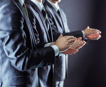 success concept: business team applauding business partners after signing the contract