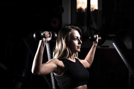business woman doing exercise on a fitness machine in a fitness centerの写真素材