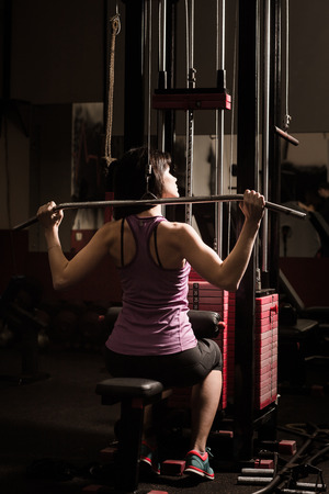 Modern business woman next to a fitness machine at a fitness lessonの写真素材