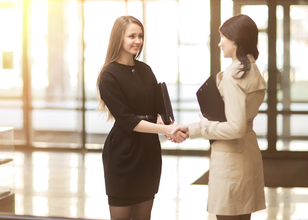 handshake of the company manager and the client in the lobby of the modern officeの写真素材