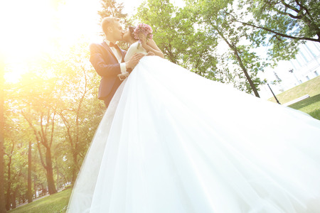 bride and groom kissing in the Park.の写真素材