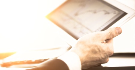 Businessman with finger touching screen in digital tabletの写真素材