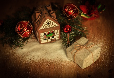Christmas present on the background of a gingerbread houseの写真素材