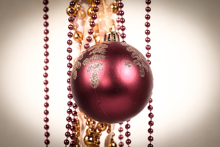 red Christmas ball and Golden garland on white backgroundの写真素材