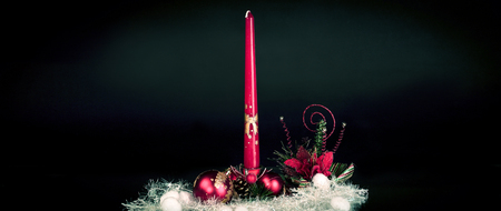 candle and Christmas composition on a black backgroundの写真素材
