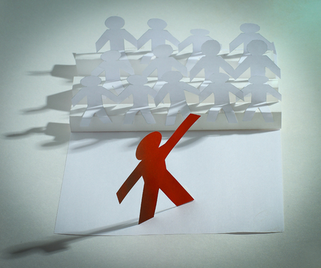 leader standing in front of a group of paper doll.の写真素材