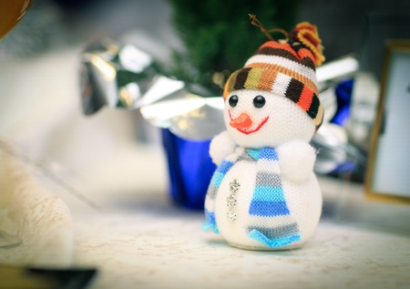 cute snowman toy and greeting card on Christmas tableの写真素材