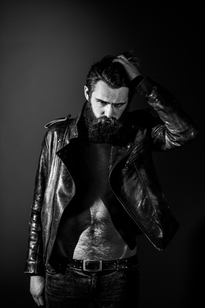 Brutal angry biker on a dark background.の写真素材