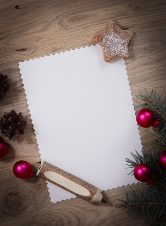 blank Christmas card and ornaments on wooden background.の写真素材