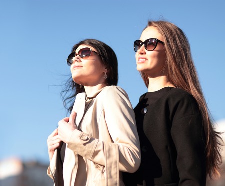 Two young beautiful girls walking the streets of the city.の写真素材