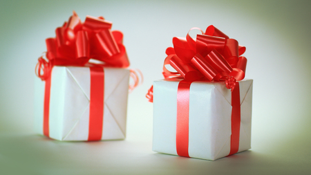 two white gift box with red ribbon .isolated on whiteの写真素材