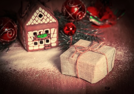 Christmas present on the background of a gingerbread houseの写真素材