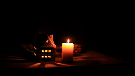 gingerbread house candle on blurred background of the table.の写真素材