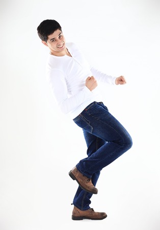 concept of success in business: a triumphant businessman is dancing on white backgroundの写真素材