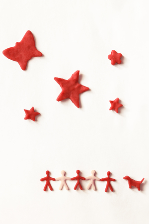 silhouettes - people, dog and stars made of dough on a light background.の写真素材